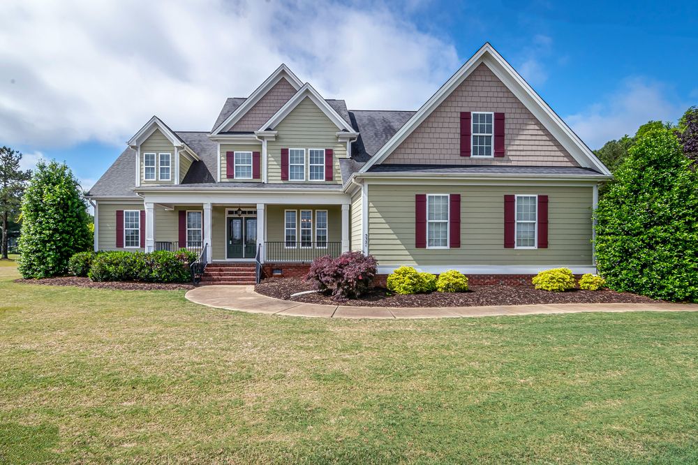 Large home finished with fiber cement siding and shake-style gable accents