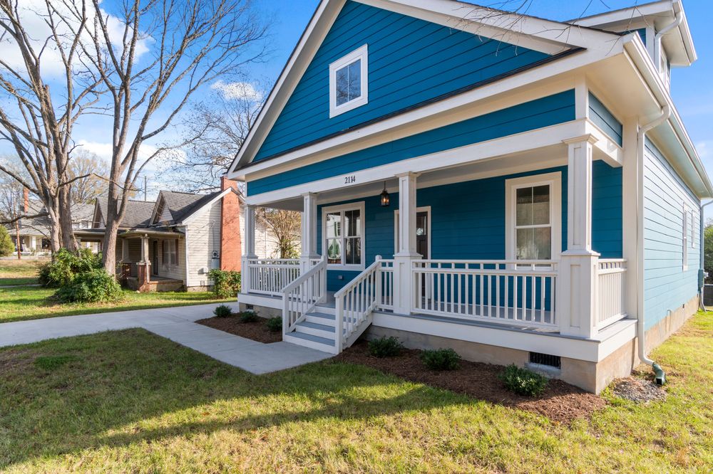 Craftsman bungalow finished with teal fiber cement siding