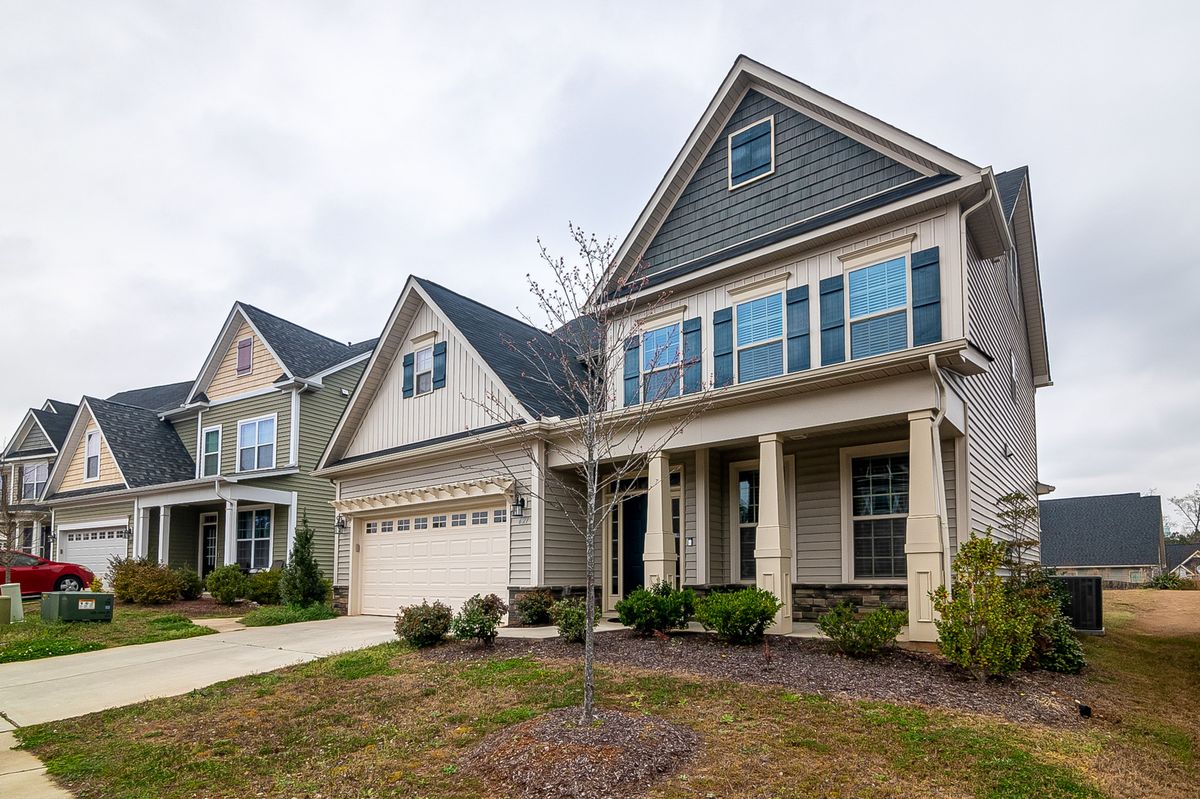Two-story home with newly replaced siding on a residential street