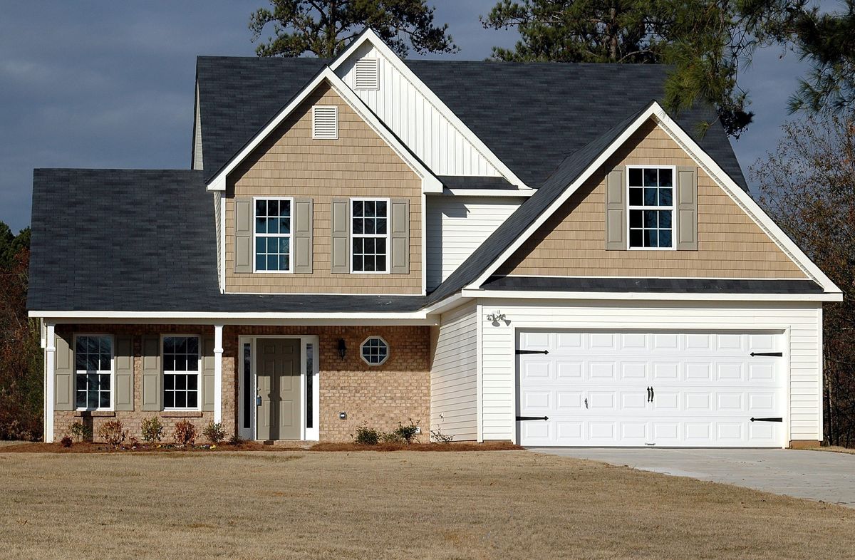 Home finished with new tan siding and brick accents