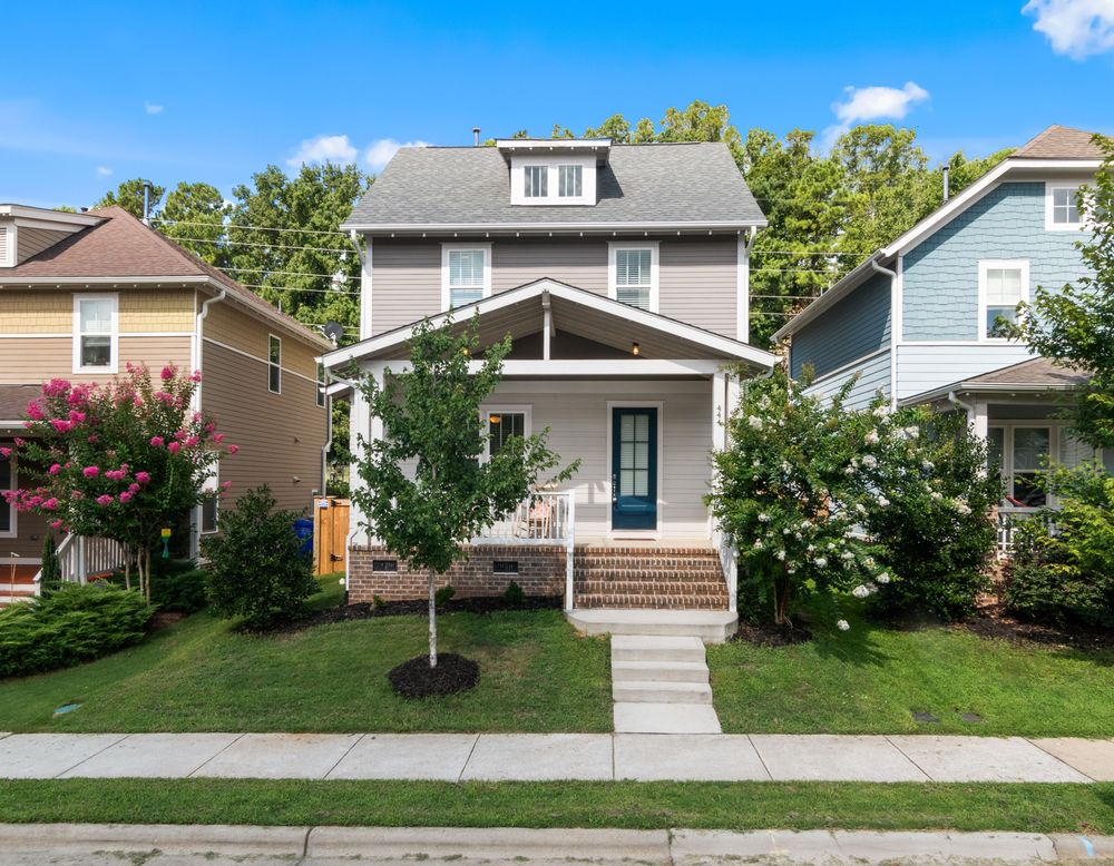 Craftsman-style home with vinyl siding on a residential street